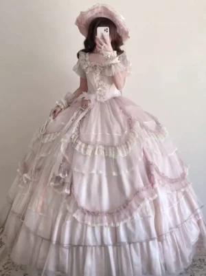 Vintage pink classic lolita ball gown full body view with boned corset bodice short puff sleeves and multi-tiered ruffled tulle skirt paired with matching wide-brim hat elegant historical aesthetic