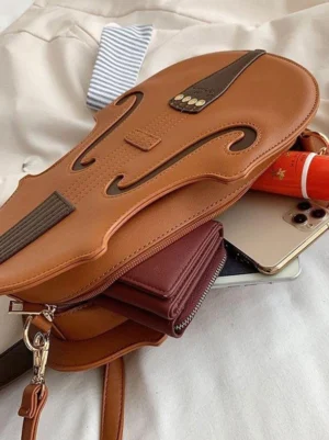 Top-down close-up view of violin-shaped Lolita handbag interior with polyester lining, main compartment open, dark brown contrast accents visible, personal items storage