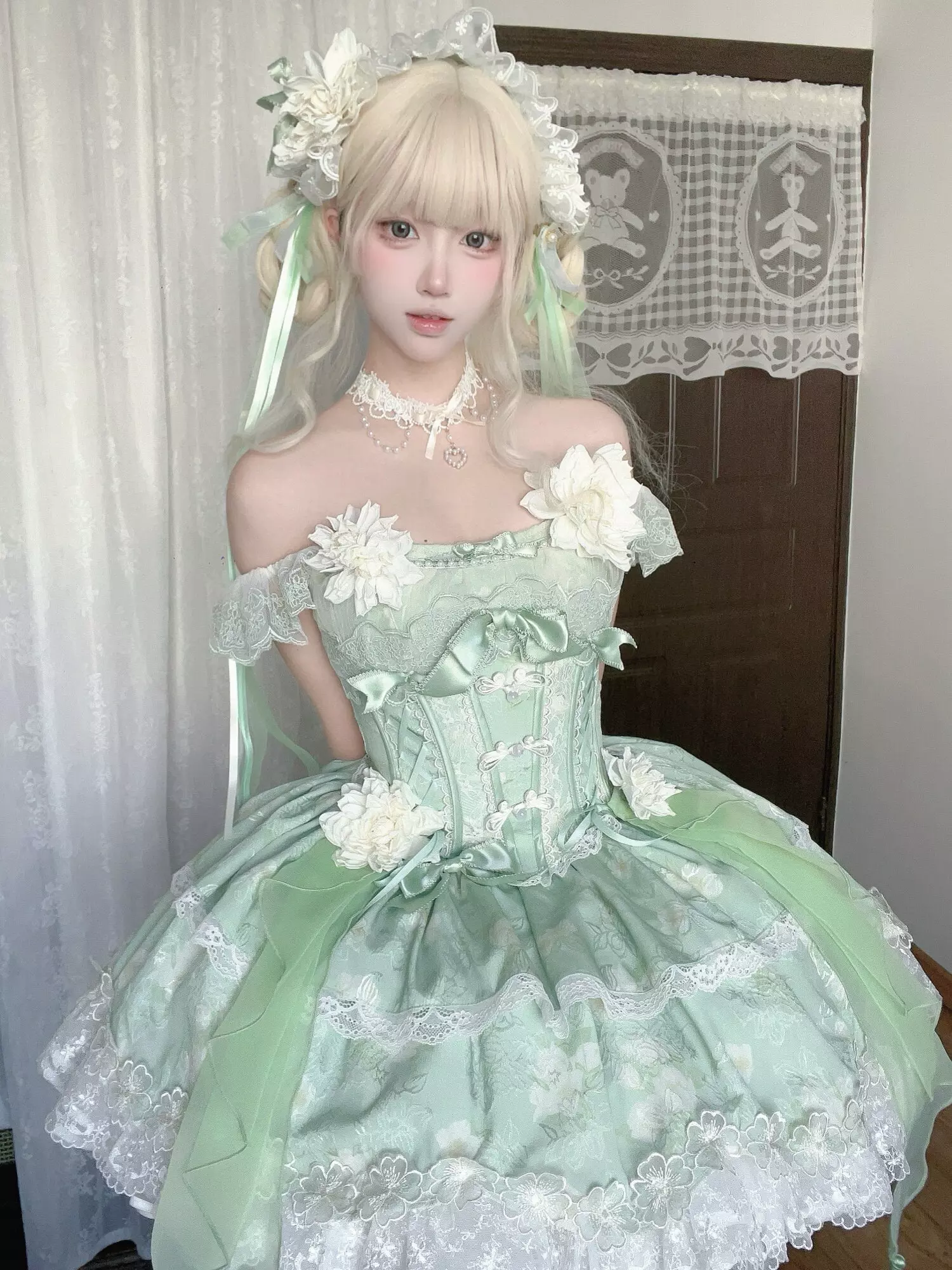 Green sweet lolita fairy dress back view showing layered ruffles bone corset structure and lace trim construction detail