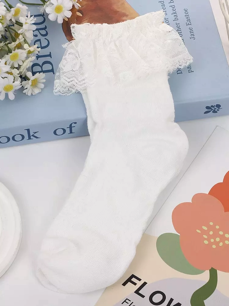 White ankle sock with wide layered lace ruffle cuff paired with vintage book and daisy flowers, styled flat lay for lolita fashion coordination