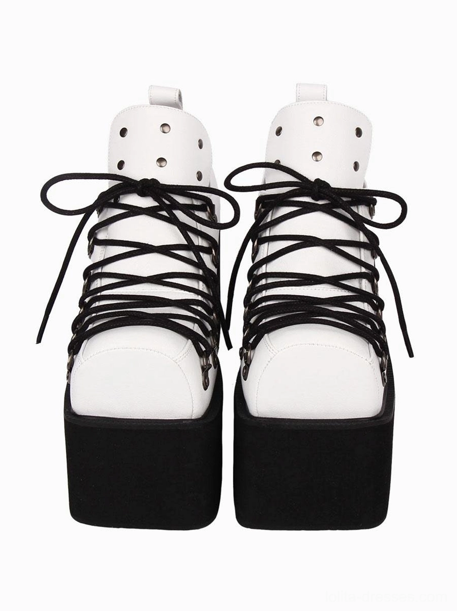 Two-tone gothic lolita platform pumps with white upper and black sole, silver grommets, front direct view showing contrast design and lace-up details