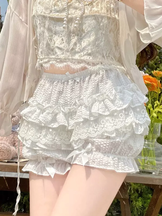 White layered lolita safety shorts side lower body close-up tiered ruffle layers dotted fabric satin leg bows garden