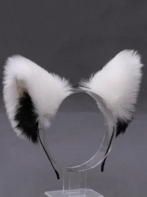 Lolita cat ear headband direct front view, white fluffy plush with black inner ear patches, clear display stand against dark background, detailed ear construction and headband base visibility