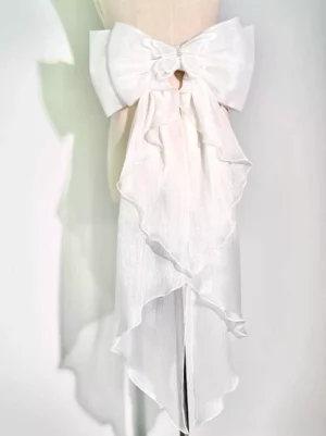 White shimmer chiffon detachable lolita bow tail accessory with ruffled tails and delicate flower decoration on dress form front view