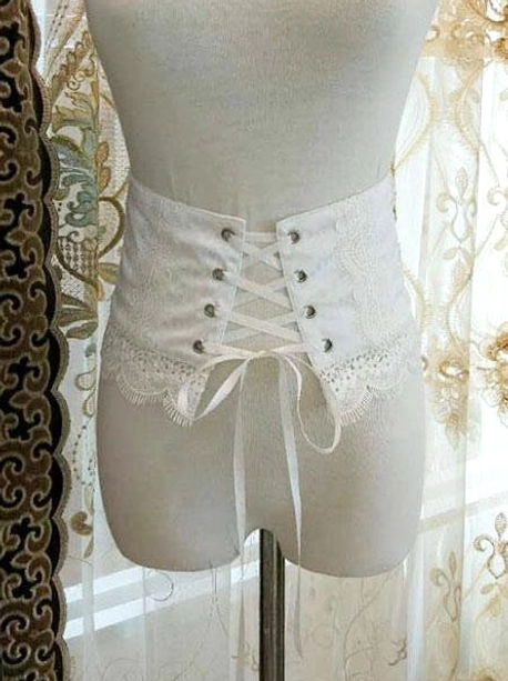 White romantic lolita corset bustier front view with metal buttons and scalloped lace hem on embroidered curtain background