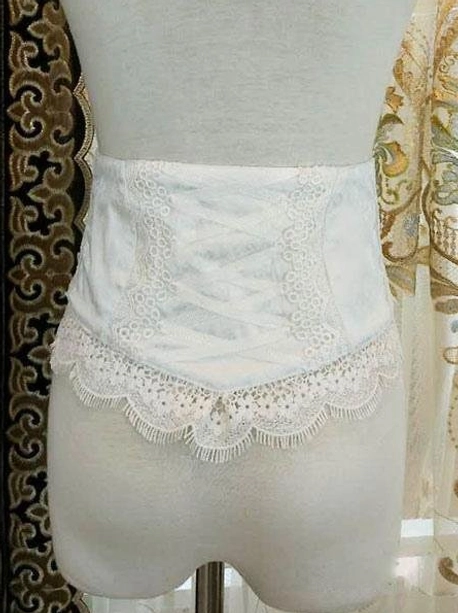White lolita corset bustier with embroidered floral lace pattern and scalloped eyelash lace trim detail front view