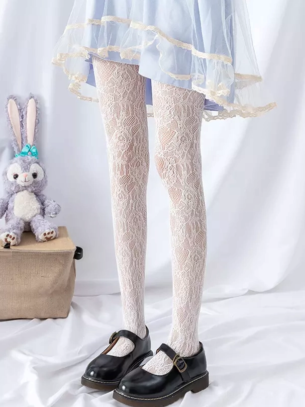 White delicate lace fishnet tights front full leg view sweet lolita style with blue ruffled skirt and black Mary Jane shoes