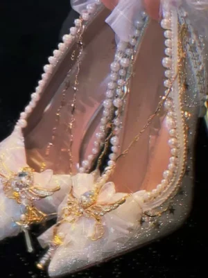 White glitter lolita stiletto heel close-up front view showing pearl trimmed opening and gemstone bow ornament