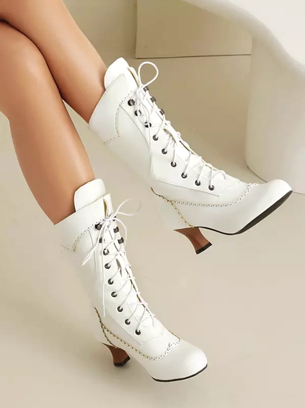 White lolita boots with perforated stitching accents metal lace eyelets matte PU surface floating side view