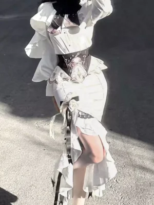 White Gothic Lolita two-piece dress back 3/4 view showcasing high-slit ruffled skirt layers and structured black corset-style waistband