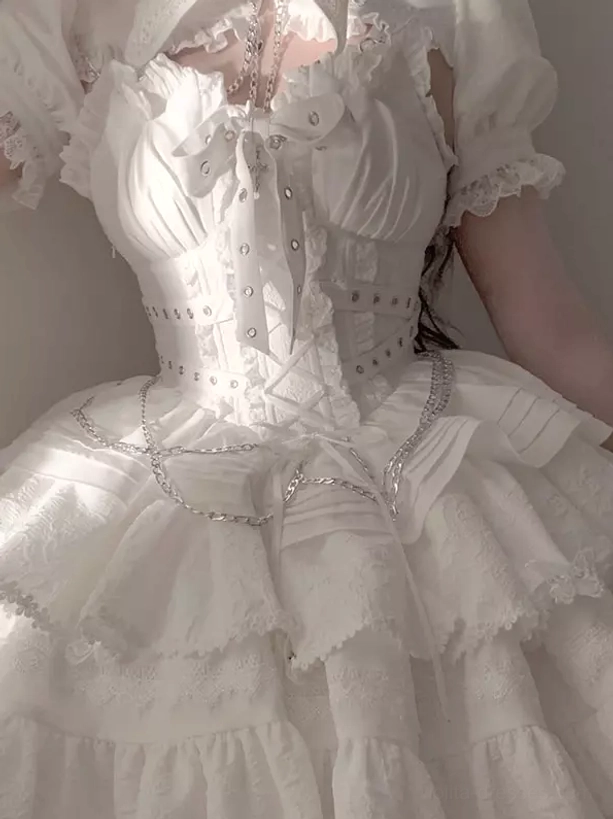 White gothic lolita dress with corset bodice chain accents ruffled tiered skirt and puff sleeves close-up front view