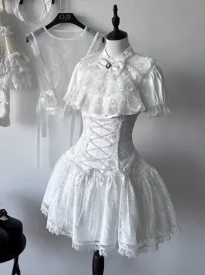 White gothic lolita ensemble front perspective displayed on dress form showing detailed lace collar capelet, structured corset waist construction, and matching sheer embroidered top - japanese lolita style dress set