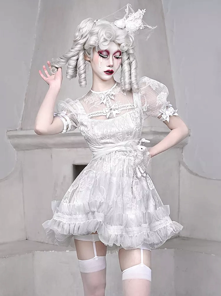 White Gothic Lolita Dress with Lace and Bows - Three Quarter Front View on Model with Gothic Styling and Fireplace Background