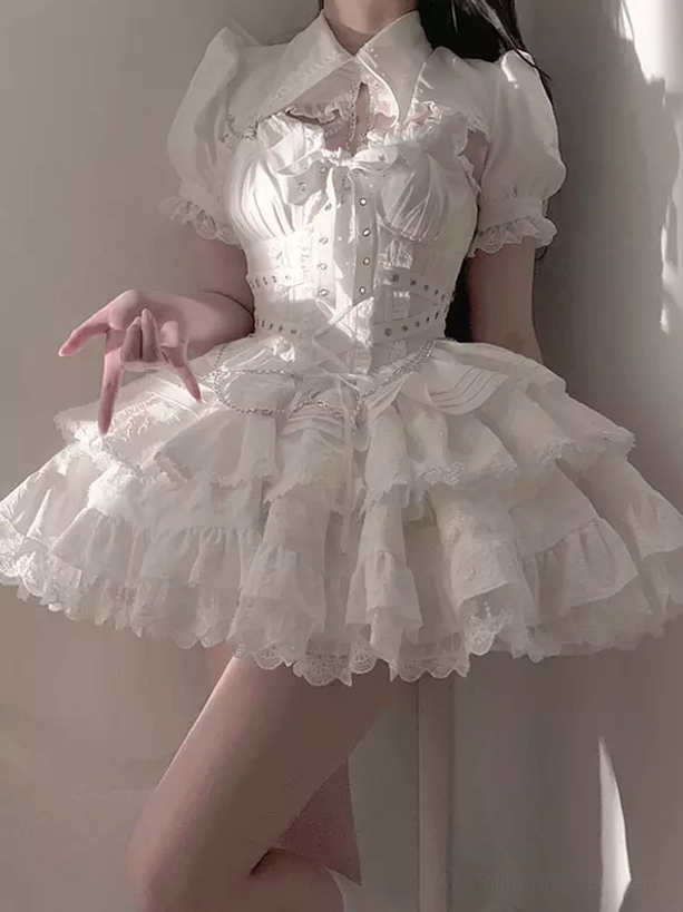 White gothic lolita jumper dress with puff sleeves corset waist and tiered ruffled lace skirt close-up partial model view