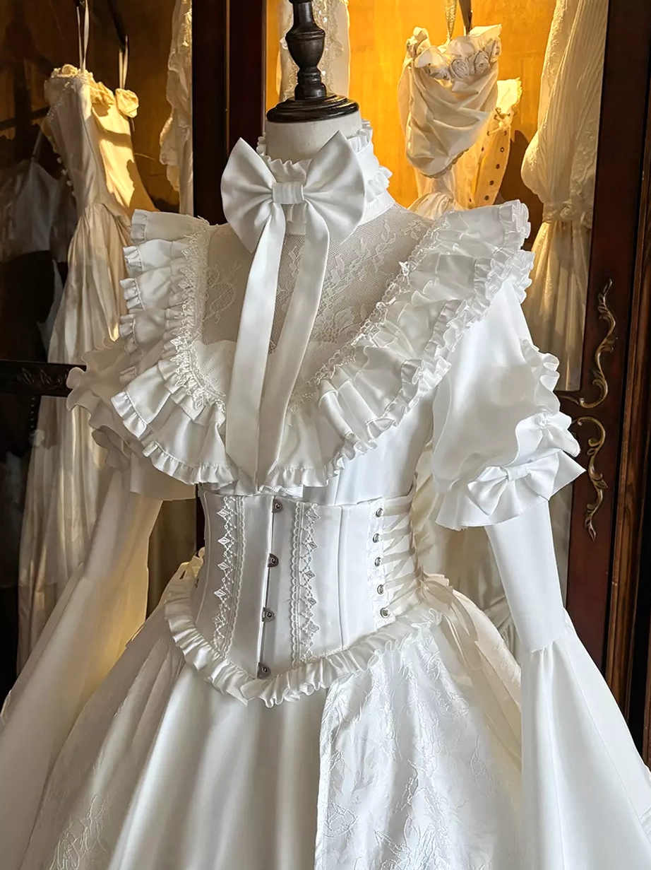 White gothic lolita dress close-up front view mannequin ruffled trims bow necktie corset waist