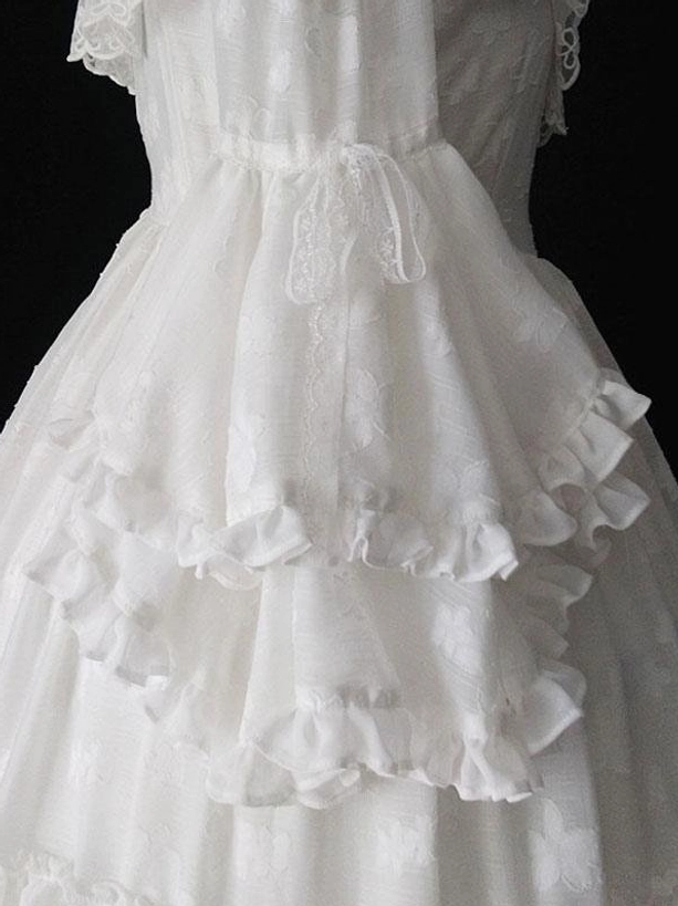 White Gothic Lolita dress waist and skirt detail close-up lace waist bow layered ruffle hem jacquard woven fabric texture