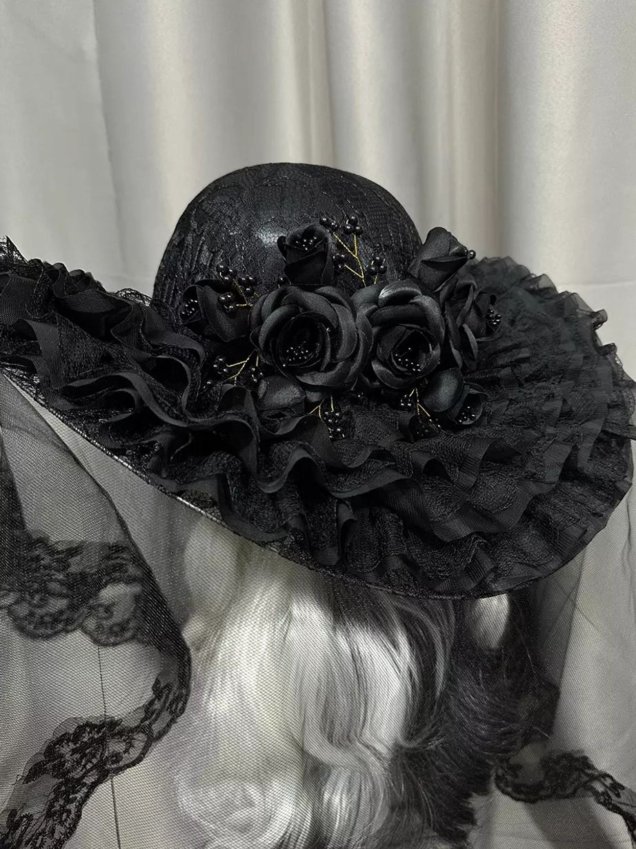 White gothic lolita wide-brimmed hat with white rose decorations and white lace-trimmed veil, left front three-quarter view on mannequin
