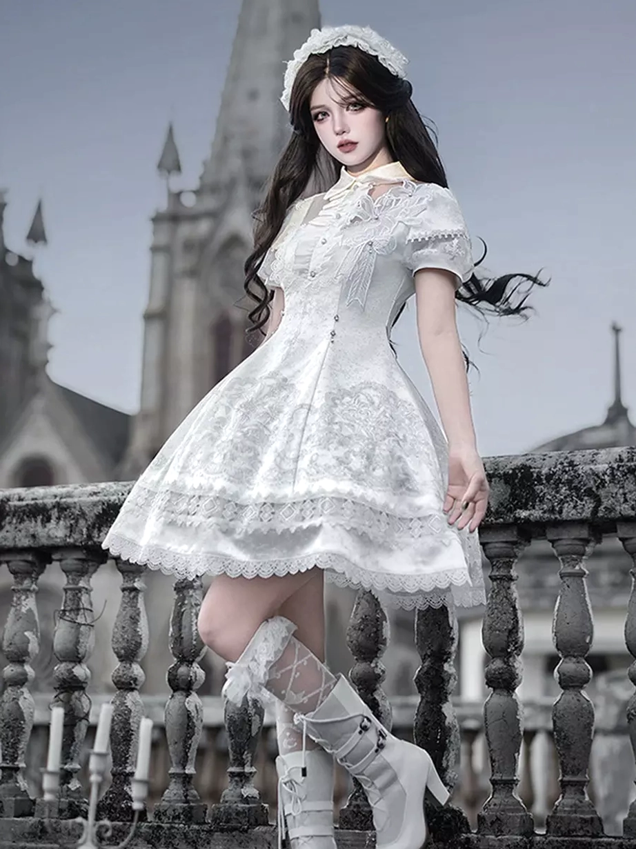 White Gothic Lolita JSK dress three-quarter side angle showing cropped A-line silhouette tailored waist block heel boots and cropped lace socks coordination