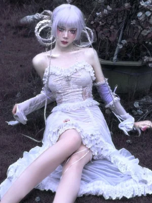 White Gothic Lolita JSK jumper skirt dress with cross pattern lace corset bodice and cascading ruffled skirt, high-angle seated fashion photography showing full silhouette and lace details