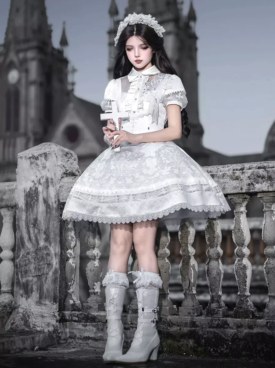 White Gothic Lolita dress full-body front view on model wearing white heeled boots and lace hairband with short puff sleeves and high-waisted A-line skirt
