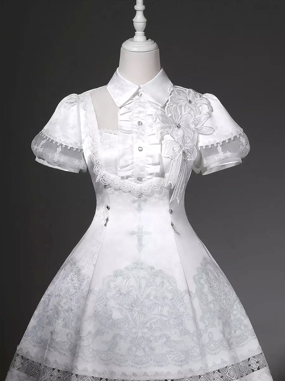 White Gothic Lolita JSK dress material detail shot showing polyester fabric quality lace embroidery scalloped hem texture and cross print design close-up