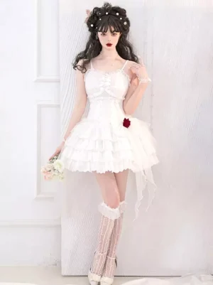 White Gothic Lolita JSK dress with ruffled tiered skirt, red rose decorations, and lace details on model full body front view