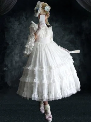 White wedding-style Gothic Lolita dress back view on model tiered ruffle skirt high waist puffed sleeves dark studio floral accessories