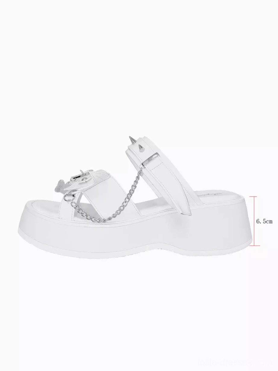 Single white Gothic Lolita platform sandal side profile on plain white background highlighting 6.5cm platform thickness, spiked straps, chain decorations, and open toe design from minimalist studio perspective