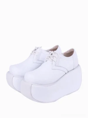 White gothic lolita platform wedge pumps with lace-up closure displayed on white background, showing three-quarter front view with thick platform sole