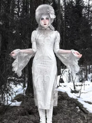 White Gothic Lolita Qipao dress with jacquard embossed texture and flared lace sleeves in snowy forest setting full front view