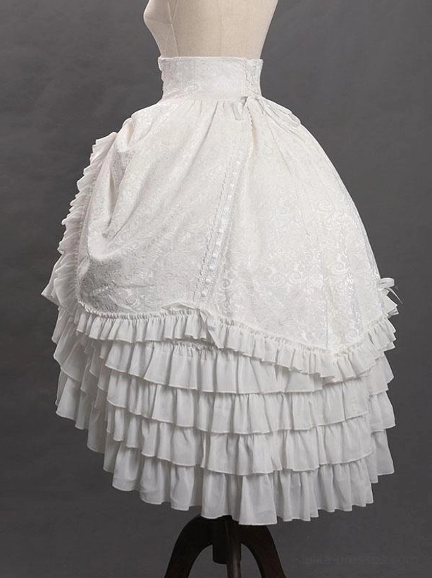 White Gothic Ouji jacquard ruffled skirt front view showing high waistline, intricate jacquard texture patterns, and dramatic tiered ruffle construction on display