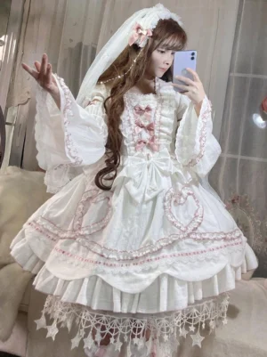 White sweet hime lolita wedding op dress with removable bell sleeves and pink accents, front mirror selfie view showing full outfit with veil and hair flowers