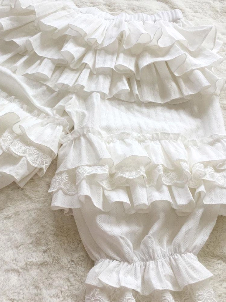 white jacquard lolita bloomers with multi-layer tiered ruffles close-up overhead view showing detailed ruffle construction and elastic waistband