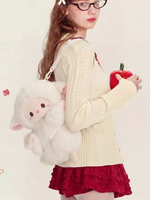 White lamb plush lolita crossbody bag worn by model in sweet lolita coordinate with cream knit top and red ruffled skirt