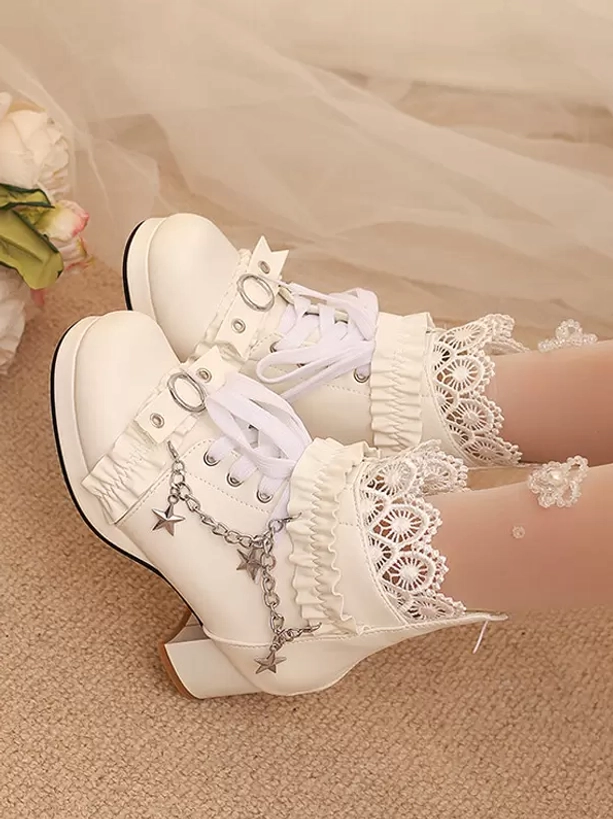 White Lolita ankle boots side oblique angle showing lace trims, star chain details, and lace-up design on indoor carpet background