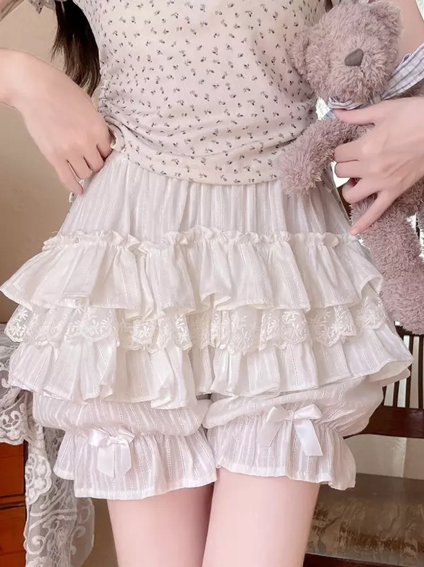 White lolita bloomers front close-up lower body tiered ruffle trim elastic waist bow decorations on model