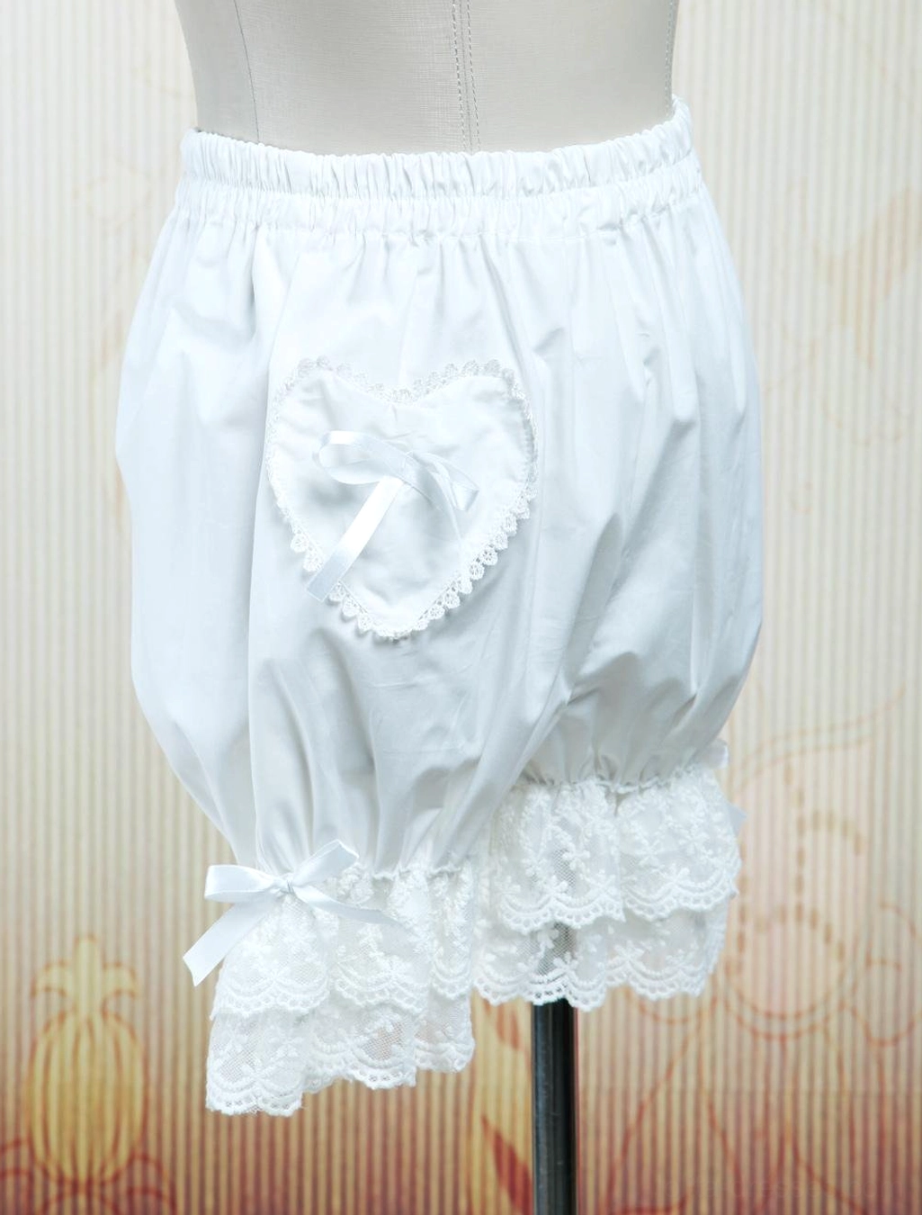White lolita bloomers front central view showing heart pocket detail and layered lace hem with satin bow on mannequin
