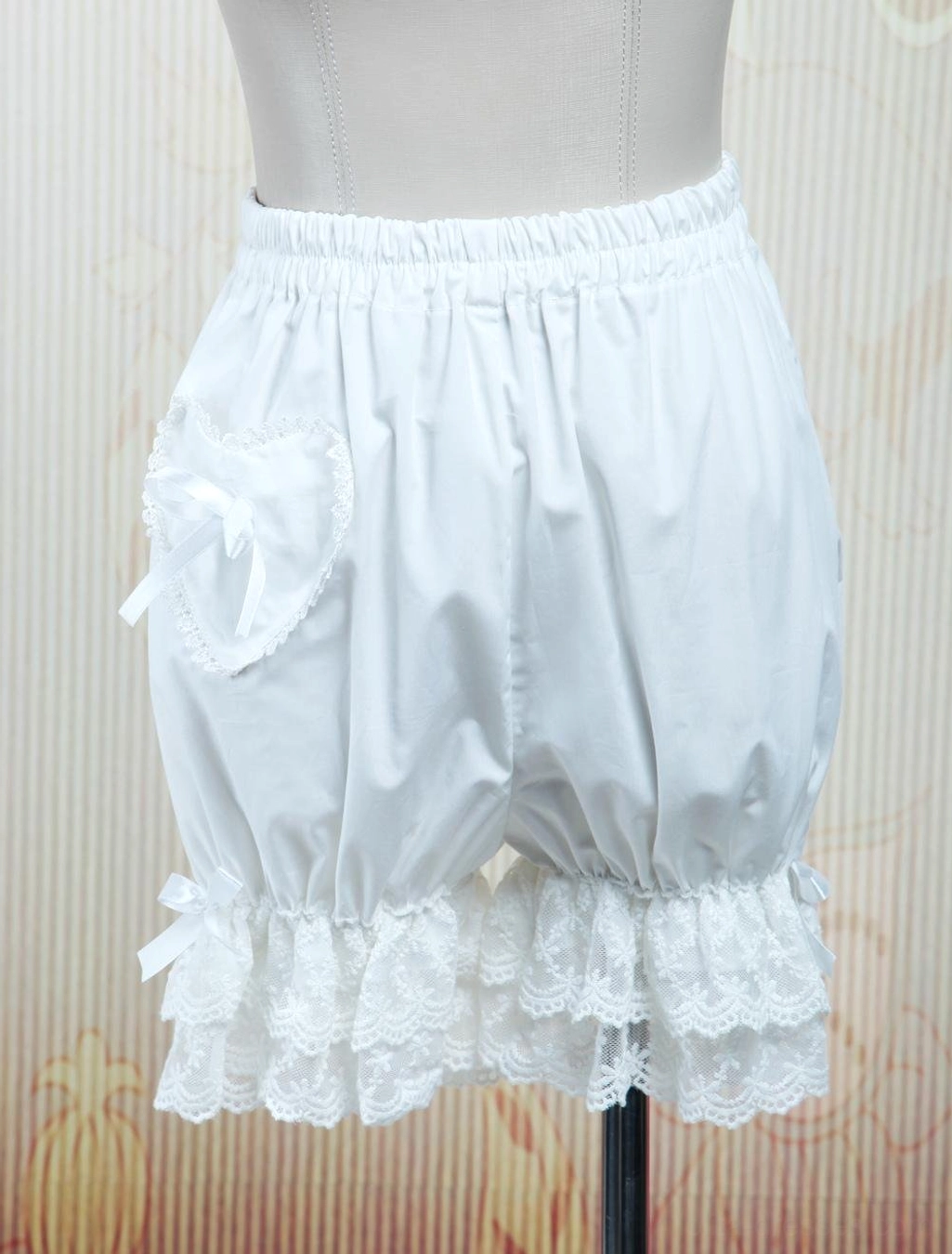 White cotton lolita bloomers with heart-shaped pocket and double-layer lace trim, left front view on dress form