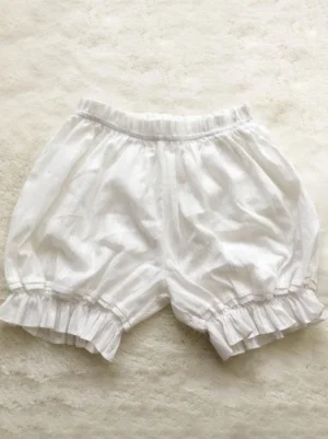 white lolita bloomers with jacquard texture loose fit ruffled leg cuffs flat lay view
