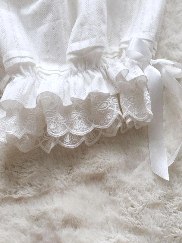 Leg cuff close-up showing layered lace ruffled trim and satin bow decoration on lolita bloomers