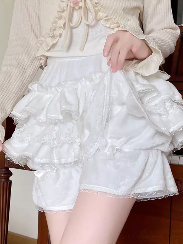 White ruffled Lolita bloomers side profile view showing layered lace ruffles, velvet fabric texture, and delicate side bow detail