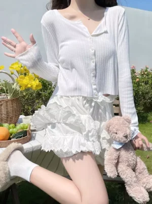 Side view of white lolita bloomer shorts featuring puffy balloon silhouette and embroidered lace layers worn during sunny outdoor picnic