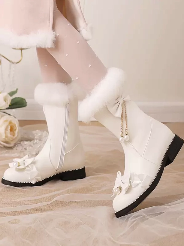 White lolita mid-calf boots featuring white fur trim, pearl tassel bows, soft fabric background, paired with pearl-dotted nude tights, three-quarter view