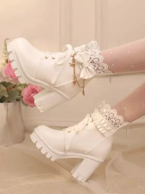 Close-up detailed view of white lolita boots showing ornate ruffled lace cuff, metal star chain bow decoration, and chunky platform heel