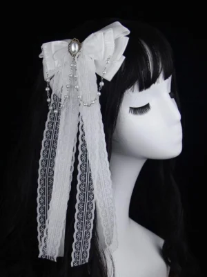 White lolita bow headdress with double satin bows and pearl brooch shown on mannequin with long black bangs wig, three-quarter side view
