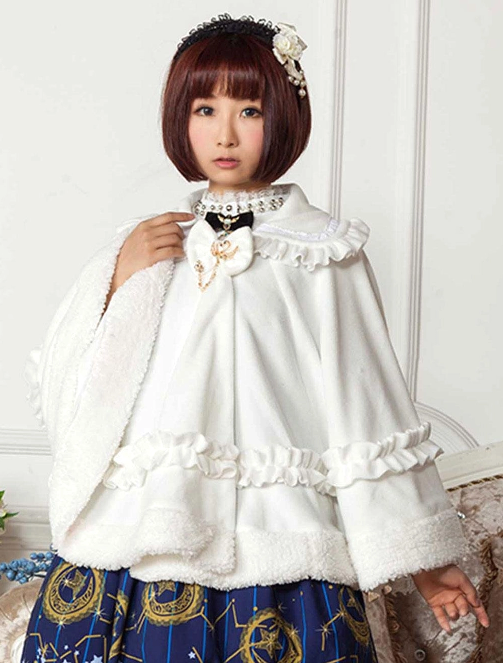 white lolita cape cloak with peter pan collar front three quarter view vintage studio setting ruffled hem