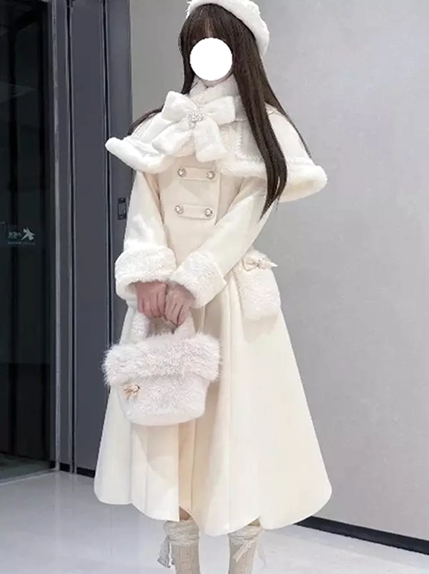 Three-quarter front view white lolita cape coat displaying fur-trimmed cuffs and wide cape collar, model carrying white fuzzy handbag