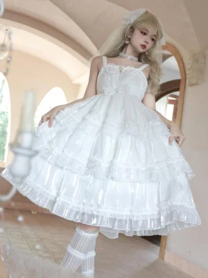 White spaghetti strap lolita dress with shirred bodice and shiny tiered ruffled skirt displayed on model from three-quarter angle in retro room with mirror