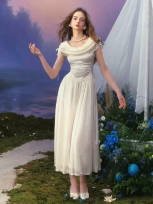 Ethereal white satin lolita evening gown with fitted waist and ankle-length skirt, modeled outdoors in a floral garden setting, showcasing the dress's graceful draping and luminous satin finish ideal for lolita tea parties and themed events