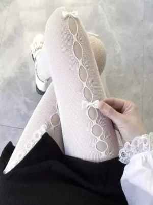 white lolita fishnet pantyhose with vertical oval cutout and bow design worn with lace-trimmed lolita dress and leg accessories